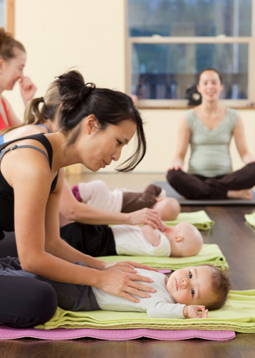 Mothers and children practising baby yoga